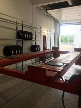 The alignment ramp and tyre racking by the open roller door